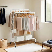 White double rod clothes rack styled with coats, scarves and storage boxes underneath