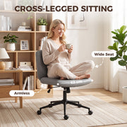 Woman sitting cross-legged on the wide armless seat