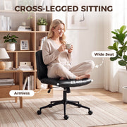 Woman sitting cross-legged on the wide armless seat