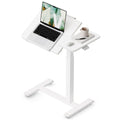 Cloud White tilting overbed laptop table with a laptop on the angled panel and a mug on the side panel
