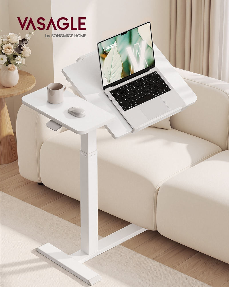 Cloud White overbed laptop table beside a cream sofa with a laptop on the tilted panel