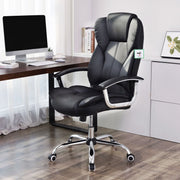 Office chair at a wooden desk in a home office with a monitor and shelves