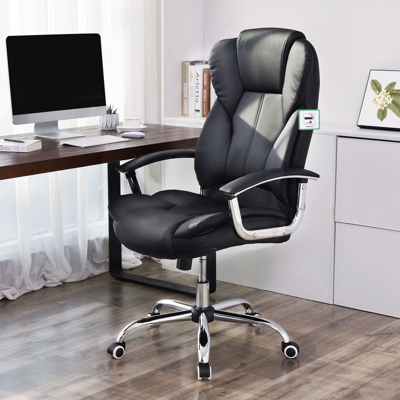 Office chair at a wooden desk in a home office with a monitor and shelves