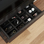 Top drawer pulled out showing 12 compartments holding jewellery, a watch and small accessories