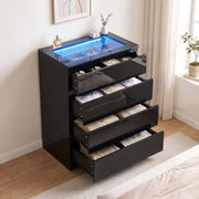 Black chest of drawers with all four drawers open showing folded clothes and the jewellery tray