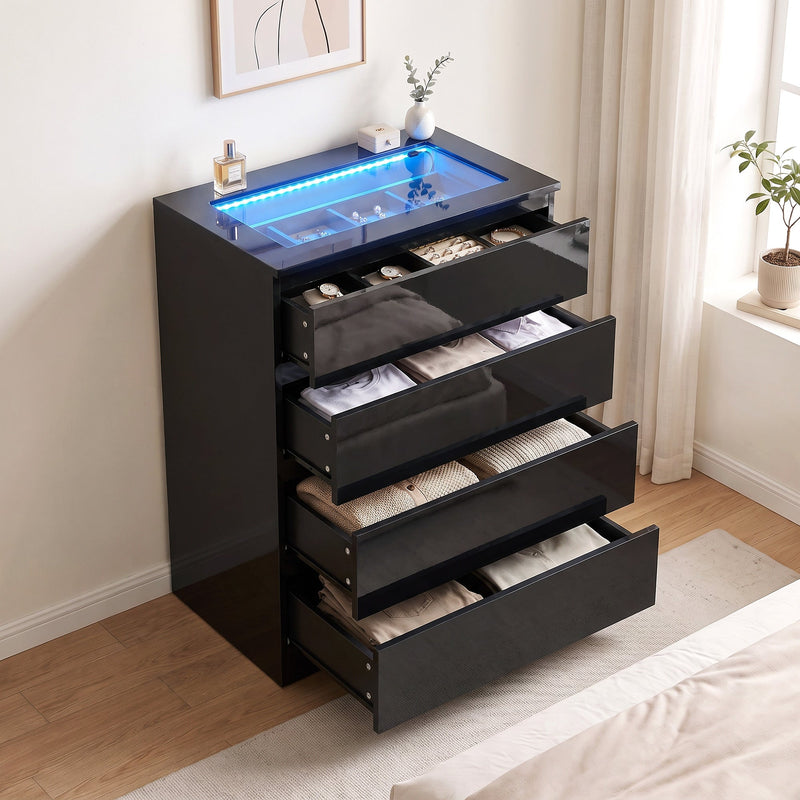 Black chest of drawers with all four drawers open showing folded clothes and the jewellery tray