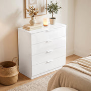 White high gloss chest of drawers styled in a bedroom with a rattan basket and plant