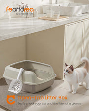 Litter box with scoop styled next to cat