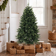 5ft tree beside a staircase with brown paper parcels and a log basket