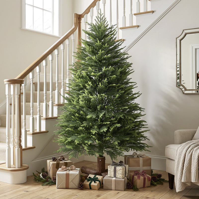 5ft artificial Christmas tree at the foot of a staircase with wrapped gifts and pine cones