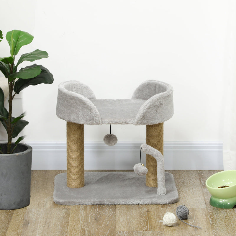 Cat tree styled indoors beside a plant and pet food bowls
