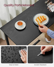 Close-up of the black particleboard tabletop showing its scratch-resistant, wipeable finish