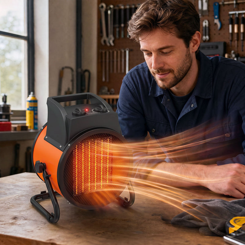 Man warming his hands at a workbench in front of the glowing orange industrial fan heater