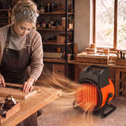 Woman working at a woodworking bench warmed by the industrial fan heater in a workshop