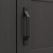 Close-up of the black door handle and wood-grain panel