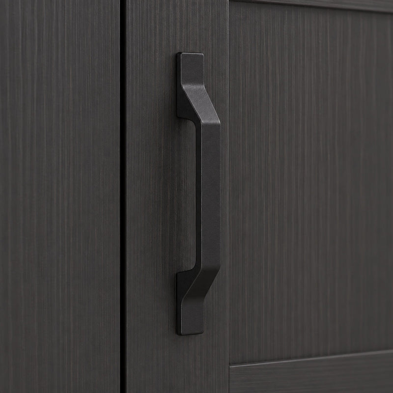 Close-up of the black door handle and wood-grain panel