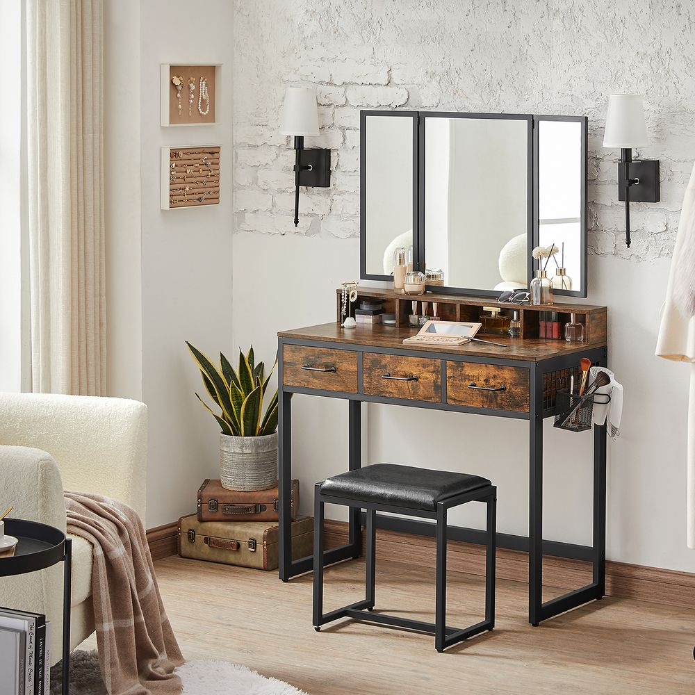 industrial style dressing table with tri fold mirror drawers shelves and a stool in a trendy bedroom