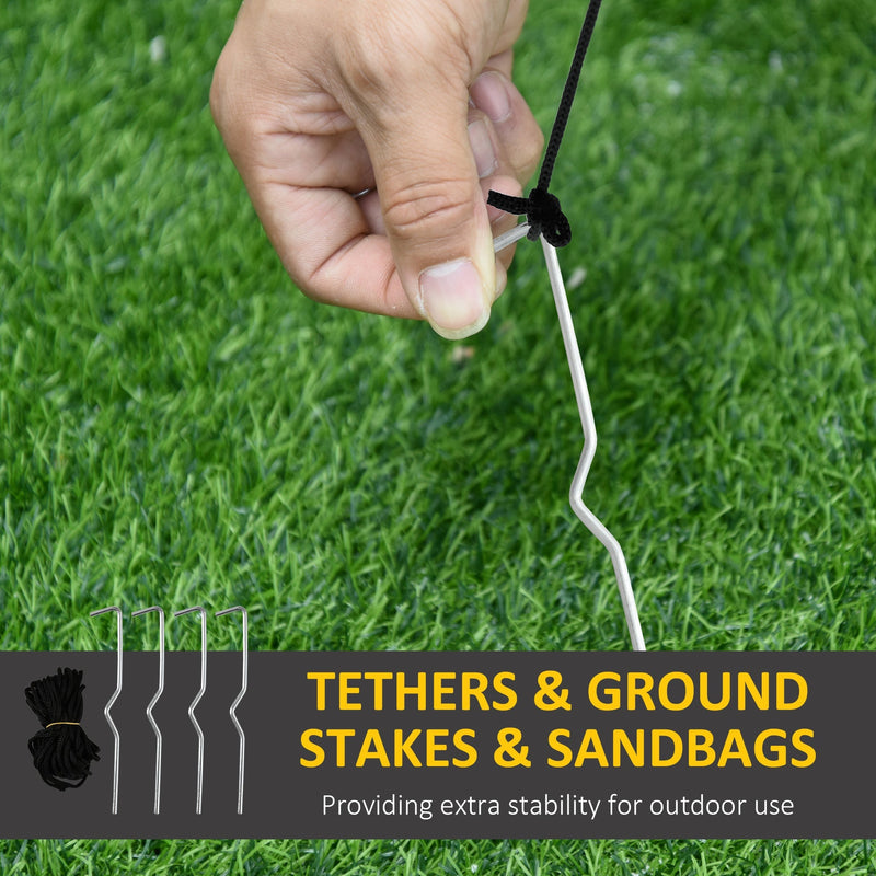 Hand pushing one of the 4 ground stakes into a lawn