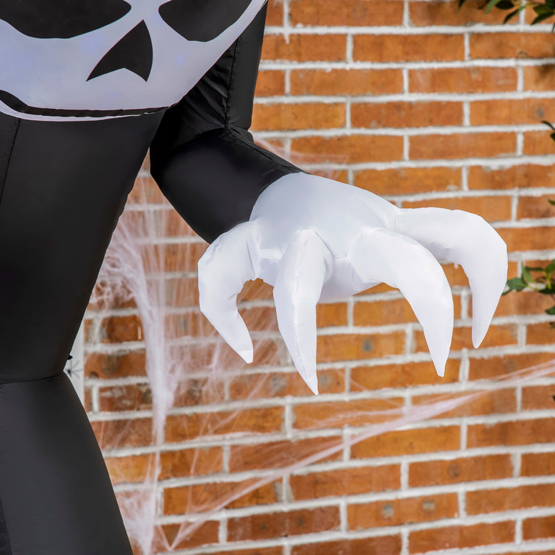 Close-up of the ghost's white clawed hand against a brick wall