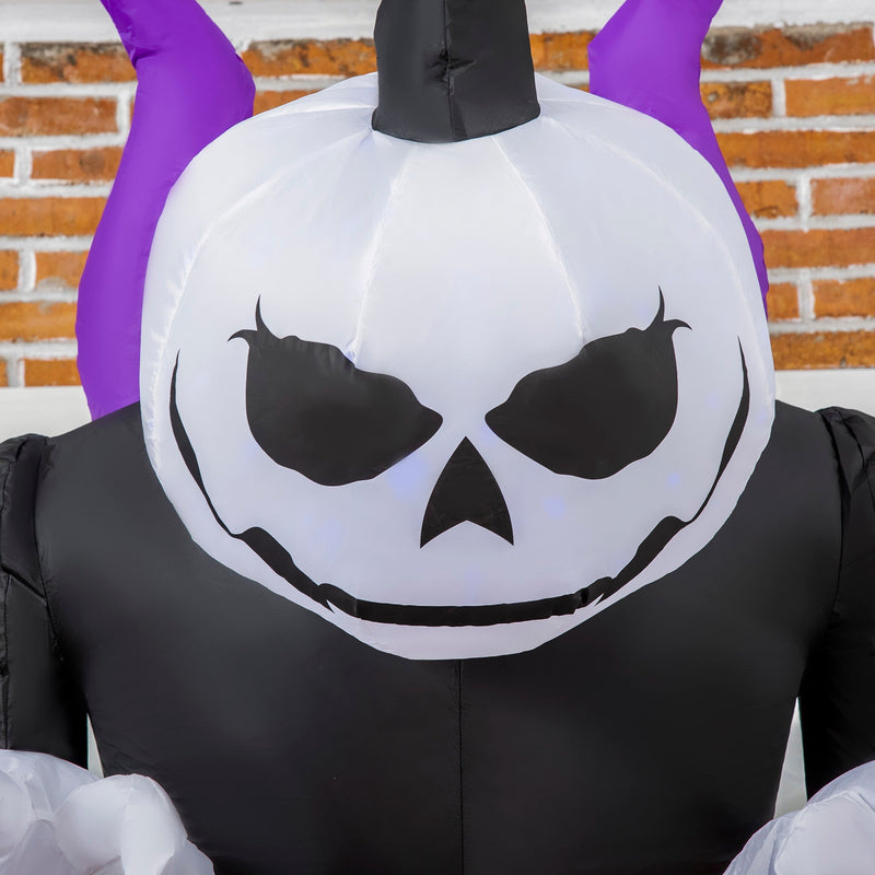 Close-up of the white skull face lit by the blue flame light, with purple horns