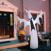White ghost inflatable standing by a front porch with pumpkins and a skeleton