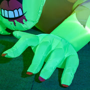 Close-up of the zombie's outstretched green hands with painted fingernails