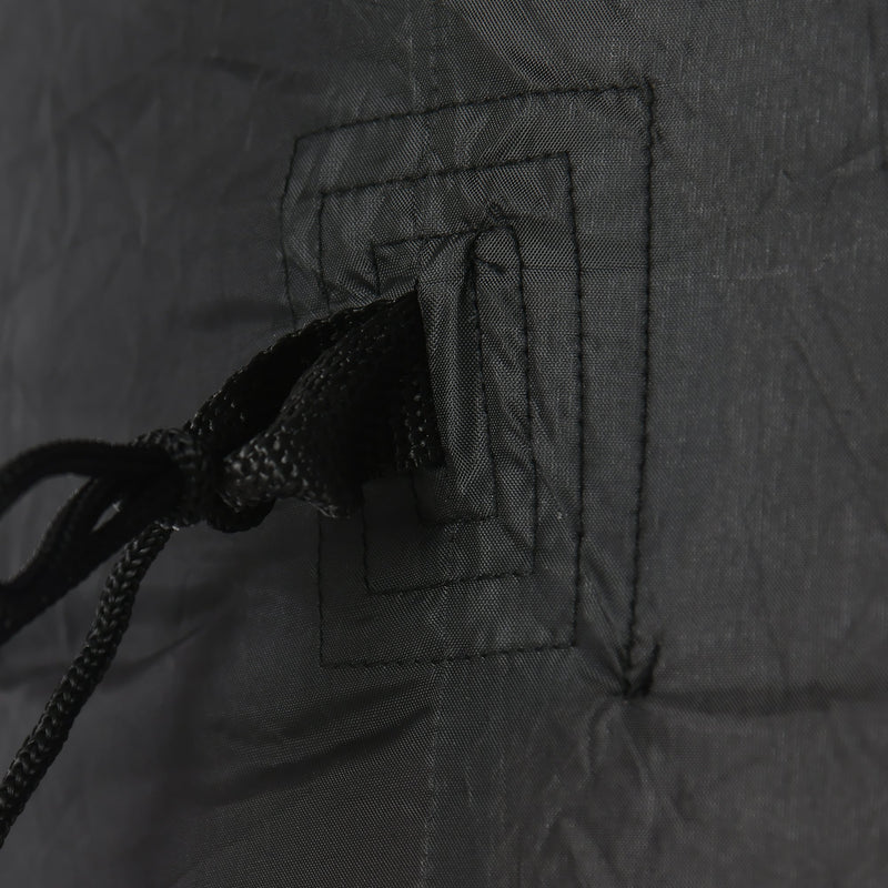 Close-up of a stitched anchor loop and tether cord on the black fabric