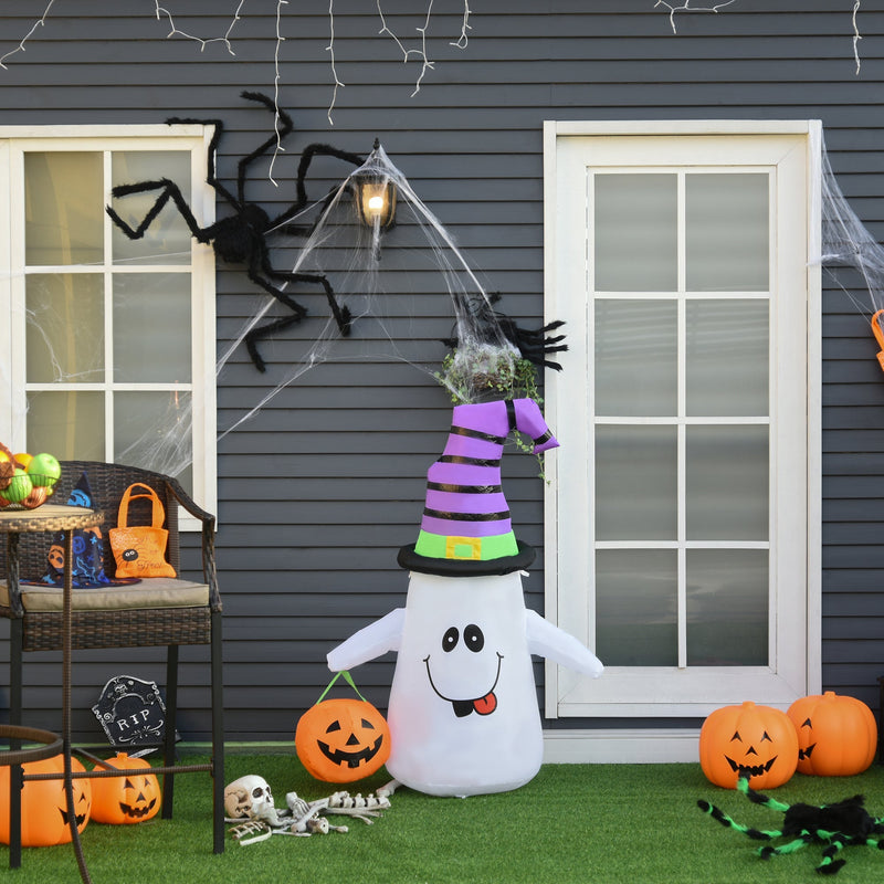 Ghost inflatable on a lawn beside pumpkins, a skeleton and a giant spider