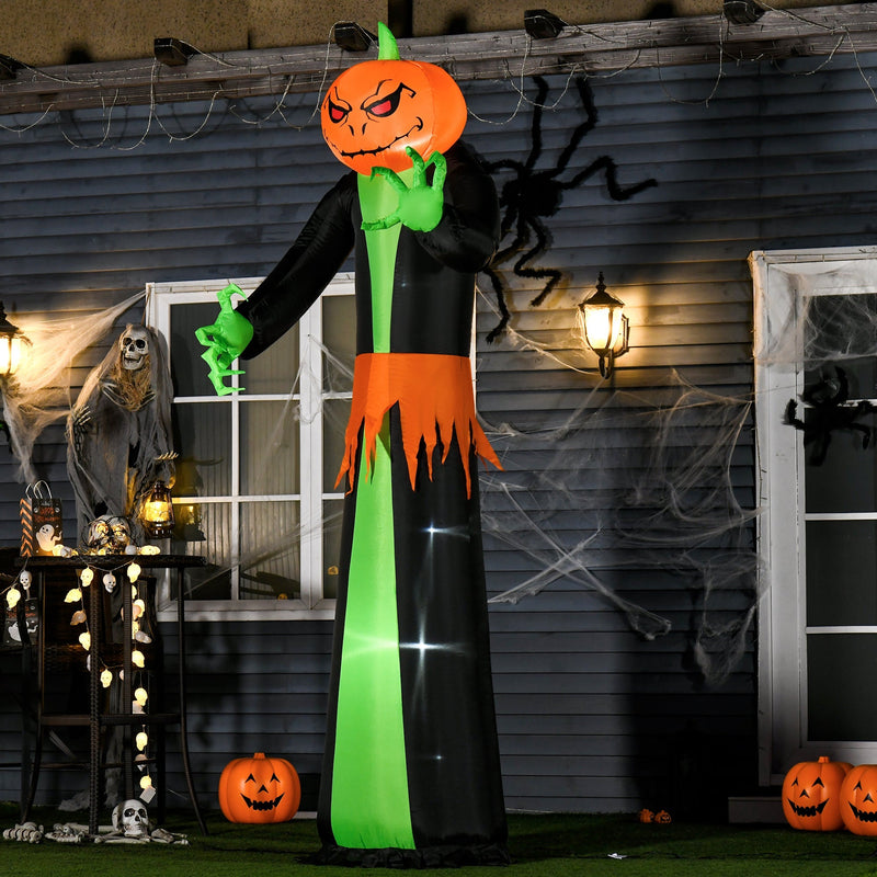 Pumpkin reaper lit up at night against a house wall hung with cobwebs