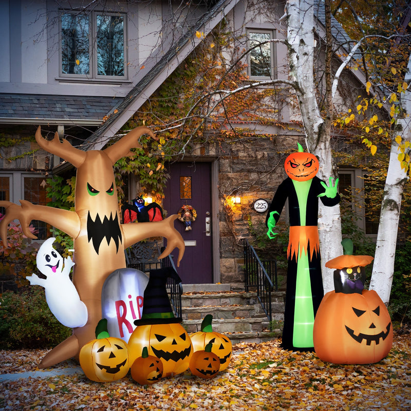 Pumpkin reaper on autumn leaves outside a house with other Halloween inflatables