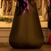 Lower half of the reaper's black robe shown against a wooden fence