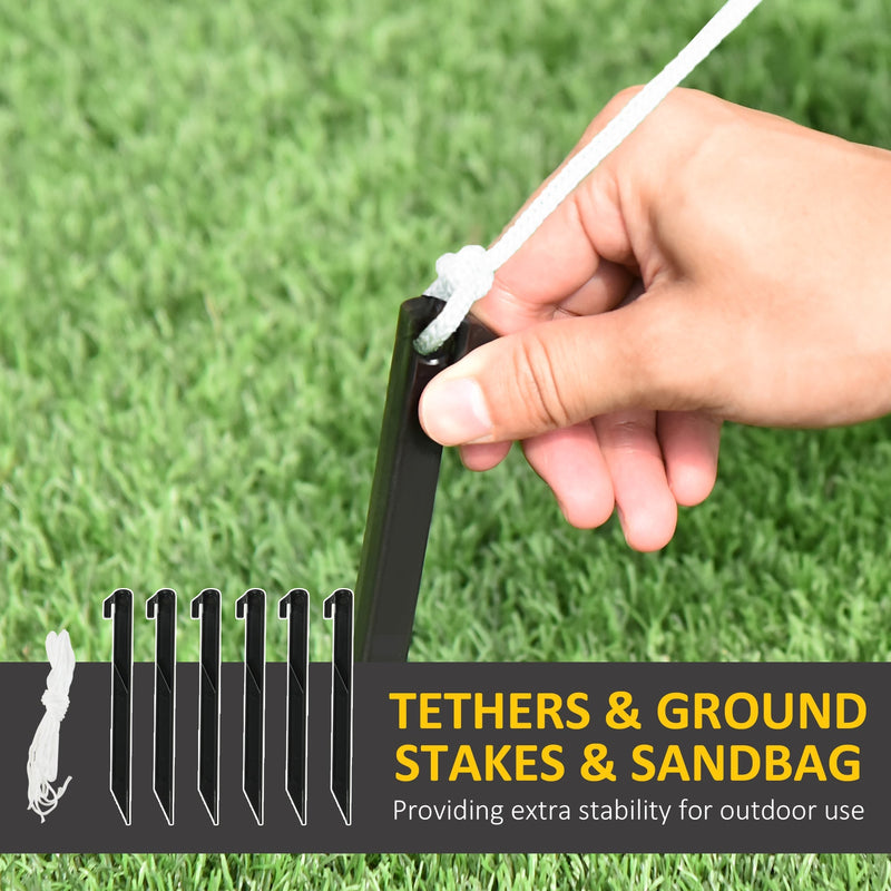 Hand pushing one of the 6 black ground stakes into a lawn