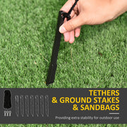 Hand pressing one of the 7 ground stakes into grass