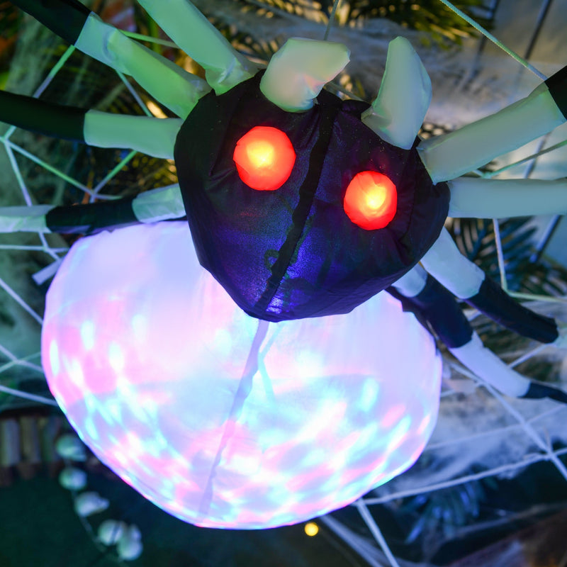 Close-up of the spider's glowing red eyes and colourful LED body lit up at night