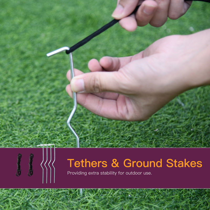 Hands pushing a metal ground stake into grass to anchor the Halloween display
