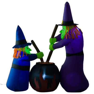 Two inflatable Halloween witches stirring a flaming cauldron on a white background