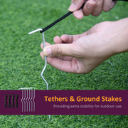 Hands fitting a ground stake into grass, with the 4 tethers and 6 stakes supplied