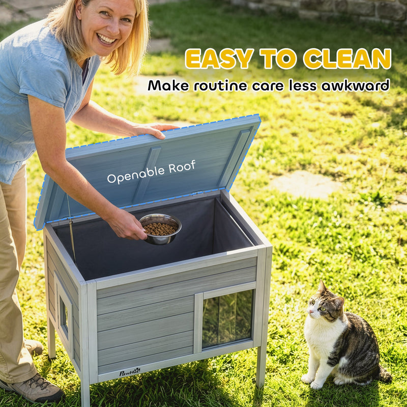 Owner lifting the openable roof to reach inside the cat house for feeding and cleaning