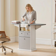 Woman ironing clothes at the Homcom ironing board cabinet in a bedroom