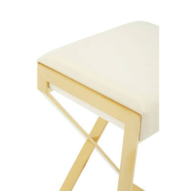 Close-up of ivory velvet seat cushion on gold bar stool