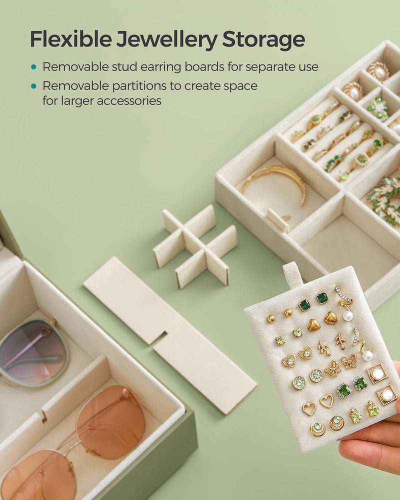 Removable stud earring board and adjustable partitions being lifted out of the jewellery box tray