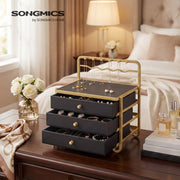 Songmics branded photo of the black jewellery box on a dark wood dresser with white roses