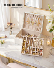 Cream white jewellery box open on a dressing table showing necklace hooks and ring compartments