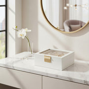 Jewellery box styled on a marble dressing table with a mirror and orchid