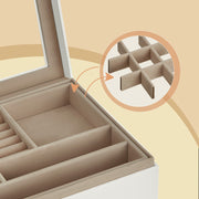 Close-up of the removable tray's velvet-lined compartments