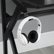 Close-up of white headphones hanging from the desk headphone hook