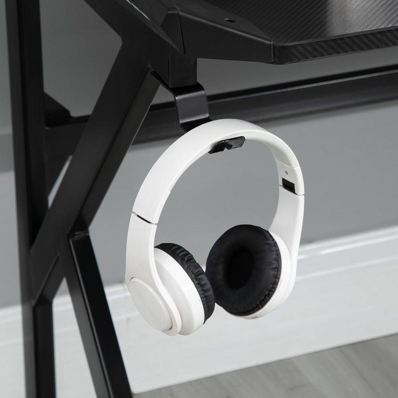 Close-up of white headphones hanging from the desk headphone hook