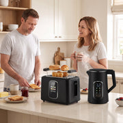 Couple using the kettle and toaster set together in a kitchen