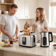 Couple making breakfast with the silver kettle and toaster set