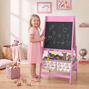 Girl smiling beside the pink kids easel with a chalk drawing in a bedroom